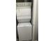 Compact laundry area with stacked washer and dryer at 361 17Th Nw St # 1717, Atlanta, GA 30363
