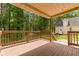 Large covered back porch overlooking lush trees, with the house in the background at 5365 Winding Ln, Suwanee, GA 30024