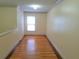 Bright bedroom with hardwood floors and natural light from a window, freshly painted and move-in ready at 5365 Winding Ln, Suwanee, GA 30024
