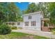 Charming two-story home featuring a spacious front yard and a side deck with wooden stairs at 5365 Winding Ln, Suwanee, GA 30024