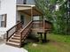 Inviting front porch with stairs, perfect for enjoying the outdoors in a tranquil, wooded setting at 5365 Winding Ln, Suwanee, GA 30024