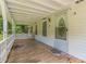 Inviting front porch with a white railing, a decorated front door, and a wooden floor at 5365 Winding Ln, Suwanee, GA 30024