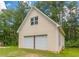 Detached two car garage with white doors and siding at 5365 Winding Ln, Suwanee, GA 30024