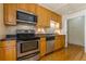 Kitchen with stainless steel appliances, wood cabinets, and hardwood floors at 5365 Winding Ln, Suwanee, GA 30024