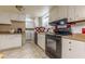 Functional kitchen with white cabinets, tiled floors, and modern appliances at 5365 Winding Ln, Suwanee, GA 30024