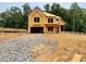 Exterior view of a home under construction shows exposed framing on a large lot with gravel and dirt at 731 Crest Line Trl, Powder Springs, GA 30127