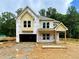 New construction featuring Hardie siding, a welcoming front porch, and an attached two-car garage at 731 Crest Line Trl, Powder Springs, GA 30127