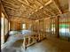 Unfinished living room featuring wood framework and large windows offering views of the surrounding landscape at 731 Crest Line Trl, Powder Springs, GA 30127