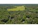 An aerial view of a house surrounded by lush forest at 2058 Sewanee Ct, Villa Rica, GA 30180