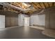 Unfinished basement area with exposed ceiling and a nearby door to a bathroom at 2058 Sewanee Ct, Villa Rica, GA 30180