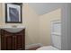 Bathroom featuring a dark wood vanity with white sink and toilet at 2058 Sewanee Ct, Villa Rica, GA 30180