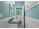 Charming bathroom with beadboard, white vanity, and coordinated fixtures at 2058 Sewanee Ct, Villa Rica, GA 30180