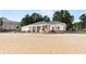 Beachfront building with a covered patio with seating on sandy beach and mature trees at 2058 Sewanee Ct, Villa Rica, GA 30180