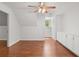 Bright attic bedroom with hardwood floors, built-in cabinets, and a ceiling fan at 2058 Sewanee Ct, Villa Rica, GA 30180