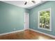 Cozy bedroom with hardwood floors, fresh paint, and a window looking out to the trees at 2058 Sewanee Ct, Villa Rica, GA 30180