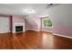Large bedroom with a decorative fireplace and hardwood flooring at 2058 Sewanee Ct, Villa Rica, GA 30180