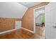 Attic bedroom with hardwood floors and an angled ceiling with door leading to adjacent room at 2058 Sewanee Ct, Villa Rica, GA 30180