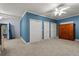Bedroom with blue walls, carpet floors, and closet space with wooden furniture at 2058 Sewanee Ct, Villa Rica, GA 30180