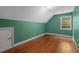 This spacious bedroom boasts hardwood floors and natural light from the window at 2058 Sewanee Ct, Villa Rica, GA 30180