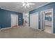 Spacious bedroom with blue walls, closet, carpet flooring and an ensuite bathroom at 2058 Sewanee Ct, Villa Rica, GA 30180