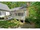 Lovely home exterior features a welcoming front porch and lush landscaping at 2058 Sewanee Ct, Villa Rica, GA 30180