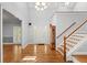 Inviting foyer with hardwood floors, high ceilings, and a striking chandelier fixture above at 2058 Sewanee Ct, Villa Rica, GA 30180