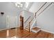 Bright foyer features hardwood floors, stairs, and a charming grandfather clock adding character at 2058 Sewanee Ct, Villa Rica, GA 30180