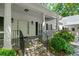 Beautifully designed front porch with stone steps, columns, and manicured shrubs at 2058 Sewanee Ct, Villa Rica, GA 30180