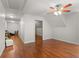 Attic hallway with hardwood floors, open doorway to bedroom with a ceiling fan and window at 2058 Sewanee Ct, Villa Rica, GA 30180