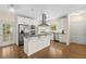 Bright kitchen features stainless appliances, a kitchen island, and door to the backyard at 2058 Sewanee Ct, Villa Rica, GA 30180