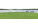 Scenic lake view showcasing a grassy lawn with benches overlooking tranquil waters, perfect for relaxation at 2058 Sewanee Ct, Villa Rica, GA 30180