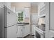 Convenient laundry area with stacked washer and dryer, white cabinets, sink, and modern appliances at 2058 Sewanee Ct, Villa Rica, GA 30180
