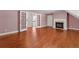 Spacious living room with hardwood floors, fireplace, and french doors leading to an adjacent area at 2058 Sewanee Ct, Villa Rica, GA 30180