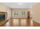 Open floor plan living room with hardwood floors, stone fireplace, and leaded glass front door at 2058 Sewanee Ct, Villa Rica, GA 30180