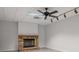 Living room featuring a stone fireplace, ceiling fan, and neutral-colored walls at 2058 Sewanee Ct, Villa Rica, GA 30180