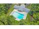 Aerial view of a large community pool with lounge chairs and picnic area surrounded by mature trees at 2058 Sewanee Ct, Villa Rica, GA 30180