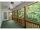 Screened porch overlooking trees, featuring wooden railings and a ceiling fan at 2058 Sewanee Ct, Villa Rica, GA 30180