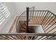 Spiral staircase featuring iron railings and tile flooring at 2058 Sewanee Ct, Villa Rica, GA 30180