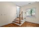Stairway to upper level features wood stairs and painted risers plus a view of the exterior at 2058 Sewanee Ct, Villa Rica, GA 30180
