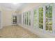 Bright sunroom featuring multiple windows, tile flooring, and a ceiling fan at 2058 Sewanee Ct, Villa Rica, GA 30180
