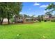 Expansive backyard with mature trees and a view of the house, carport, and a sunroom at 2135 Knighton Dr, Atlanta, GA 30349