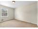 Bright, empty bedroom with a window offering natural light and neutral colored walls at 2135 Knighton Dr, Atlanta, GA 30349
