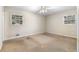 Empty bedroom featuring a ceiling fan and two windows offering natural light at 2135 Knighton Dr, Atlanta, GA 30349