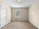 Neutral bedroom with carpet, a single window, white trim, and a door at 2135 Knighton Dr, Atlanta, GA 30349