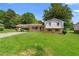 Charming two-story home with a carport, a well-maintained lawn, and mature trees at 2135 Knighton Dr, Atlanta, GA 30349