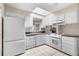 Bright kitchen featuring white cabinetry, appliances, and a view to the back yard at 2135 Knighton Dr, Atlanta, GA 30349