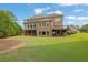 Beautiful backyard featuring a patio, sunroom, and well-maintained lawn at 2450 Weber Heights Way, Buford, GA 30519
