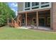 Exterior view of a home showcasing the deck, backyard, patio, and lush green lawn at 2450 Weber Heights Way, Buford, GA 30519