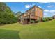 Expansive backyard with lush lawn and wooden deck perfect for outdoor entertaining at 2450 Weber Heights Way, Buford, GA 30519