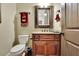 Cozy half bathroom features custom vanity with granite countertop and decorative mirror at 2450 Weber Heights Way, Buford, GA 30519